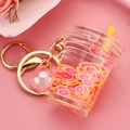 Macro detail of acrylic beverage keychain with pink liquid and citrus slices charm - Pink Cup