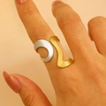 Detail of 18K gold and silver two-tone irregular wavy open ring worn on a finger - 18K Gold Two-Tone Wave (G352)
