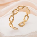 Minimalist golden stainless steel chain link open bangle displayed on a marble stone - Chain Link / Gold