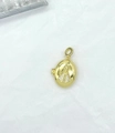 Detailed close-up of golden oval pendant featuring religious figure and inlaid crystals - Oval Virgin Mary