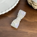 Elegant white iridescent bow hair clip with hollow design on a rustic wooden surface - Hair Clip / Iridescent White