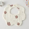 Detail of petal-shaped cotton baby bib featuring a cute brown bear pattern and snap button - Gauze Flower Wrap - Planet Bear