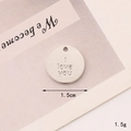 Macro shot of silver I Love You pendant showing 1.5cm diameter and 1.5g weight detail - C086 15mm Silver I Love You Round Tag