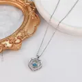 Silver heart pendant necklace with a brilliant blue center stone on an elegant chain - Moving Blue Heart (XL971)