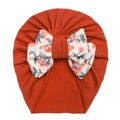 Detail view of baby turban hat in orange with a large floral knot bow decoration - Orange