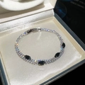 Close-up of 18k gold plated double layer bracelet with black marquise zircon stones - Silver-Black