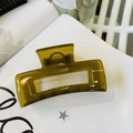 Detail of olive green rectangular hollow hair claw clip with golden metal spring - Jelly Yellow Green
