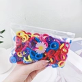 Detail of colorful elastic hair bands in a transparent daisy print storage bag - Dark Color Daisy Bag