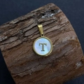 Gold round pendant with white shell inlay featuring a letter T on rustic bark - Letter T / 17x20mm