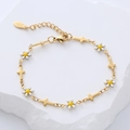 Detail of 18k gold plated bracelet with white enamel daisies and gold cross charms - White Flower
