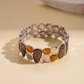 Dettaglio di bracciale vintage elastico con resina ambra e smalto a spirale marrone - Argento-Caffè