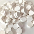 Stack of white disposable compressed cotton face towels in coin shape for travel - Naked/No Packaging / Single Piece