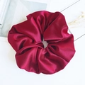 Oversized burgundy satin scrunchie with glossy pleated texture and soft fabric finish - Burgundy