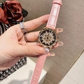 Detail of pink leather watch with rotating snowflake diamond dial and gold case - Rose Gold Pink Leather Strap