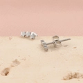 Silver stainless steel stud earrings featuring three linked stars on a stone surface - Steel Color Stars (MP402)