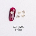 Macro detail of 6x5mm gold heart nail charms with AB rhinestones on a white surface - Gold Heart Aurora Rhinestone Style(8709)