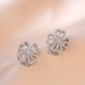 Silver flower stud earrings with micro-set cubic zirconia on champagne satin background - Heart Clover Earrings (E0121) / Silver