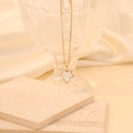 Detail of gold maple leaf pendant with iridescent white inlay on stainless steel chain - Opalite