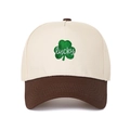 Detail of leaf embroidery and lucky text on a color-block 5-panel trucker hat - Adjustable / Cream/Coffee