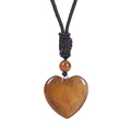 Macro shot of heart-shaped brown tiger eye stone pendant with adjustable cord necklace - Tiger's Eye