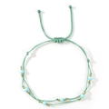 Bohemian light green woven rope bracelet with light blue beads and golden metal accents - Light Green/Azure