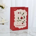 Elegant red gift bag with vintage rose illustration and durable woven handles - Cupid's Arrow