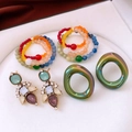 Flat lay of vintage-style drop earrings with rhinestones and colorful beaded jewelry sets - Silver Pin Vintage Earring Set (3 Pairs)
