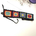 Handmade granny square crochet headband in black with colorful bohemian flower patterns - Rainbow Black