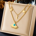 Gold double-layered necklace with turquoise sun, star, and moon charms on a display box - Turquoise Sun Star Moon Double Layered Style (N2512)