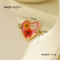 Macro shot of gold heart ring featuring real dried flowers in pink resin with crystals - Pink Heart (NMSR-F629-1)
