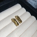 Detail of yellow-green rectangular faceted gemstone earrings with silver four-claw setting - Large / Yellow