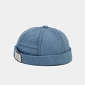 Detailed texture of blue denim docker cap with white New World embroidered patch - Medium Blue