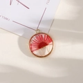 Golden round resin pendant featuring a real red dried daisy flower for DIY jewelry - Style 19
