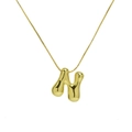 Detailed view of polished 18k gold bubble letter N pendant on a delicate chain necklace - Letter N