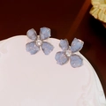 Macro shot of blue crystal flower earrings with silver needles and a zircon center - 925 Silver Needle / Blue