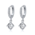 Macro shot of S925 sterling silver hoop earrings with clear round cubic zirconia stones - Silver