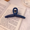 Deep blue matte large hair claw clip for women on book background, sleek accessory - Matte Navy Blue