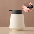 Speckled beige ceramic soap dispenser with dark gray pump in a modern conical shape - Straight / Off-white with Grey Pump