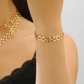 Detailed view of golden tank chain bracelet with vintage watchband style links on wrist - Watch Strap Style Bracelet (Gold)
