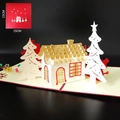 Detail of 3D pop-up Christmas card featuring laser-cut gold and white house in snowy forest - Christmas Snow House