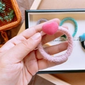 Primo piano di un elastico per capelli rosa peluche con dettaglio a cuore floccato - Cuore Rosa