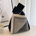 Detail of knitted tote bag with black and white geometric pattern against a decor background - Black Nordic Geometric