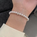 Elegant white pearl bracelet with a sparkling silver rhinestone charm on female wrist - Creamy Pearl Silver Zirconia Ball (MY36746)