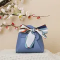 Morandi blue leather wedding favor bag with decorative silk ribbon bow on knit fabric - Sapphire Blue
