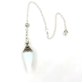 Macro shot of white crystal pendulum with vintage silver metal filigree and silver chain - White