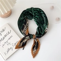Pleated silk scarf with green and brown leopard print pattern shown in a knotted loop - Green Leopard Zebra Print