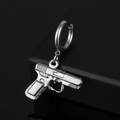 Macro detail of silver stainless steel pistol pendant with 020 engraving on black background - Handgun