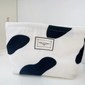 White corduroy cosmetic bag with black cow print and Time to Party woven label - Large / Cow Print