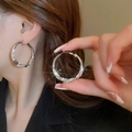 Macro shot of silver C-shaped twisted hoop earrings with sparkling pavé cubic zirconia - 69# Silver Post Style (32mm)(69#) / 32mm Diameter / Silver