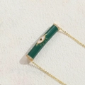 Golden necklace featuring a green enamel cylindrical pendant with evil eye and zircons - Green